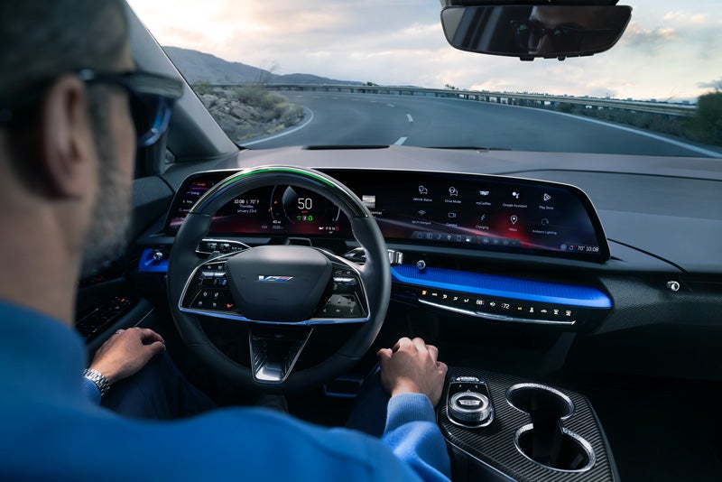 Front View of the 2026 OPTIQ-V Driving Through the Dusk Utilizing its Headlights | Corwin Cadillac Reno in Reno NV
